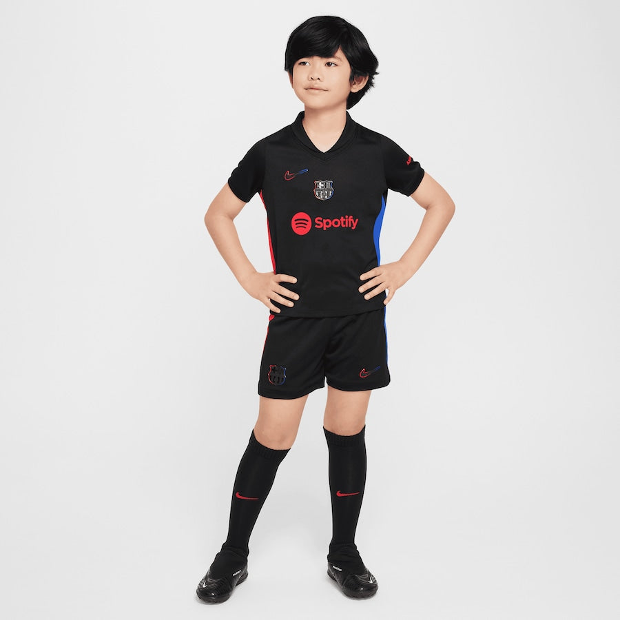 Kid wearing official Puma Barcelona away kit 2024-25 kid in black with red and blue details